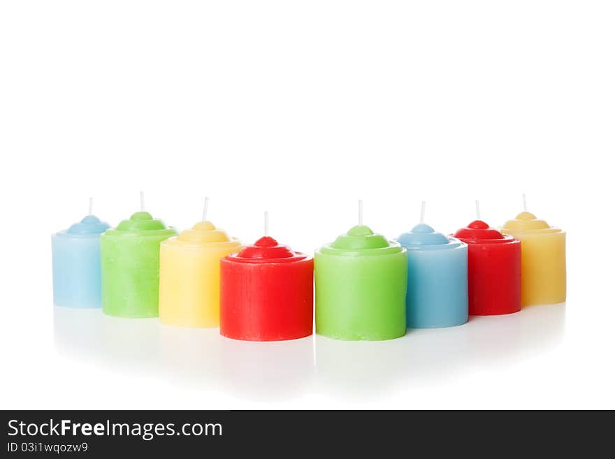 Colorful short candles without flame. Isolated over white background. Colorful short candles without flame. Isolated over white background