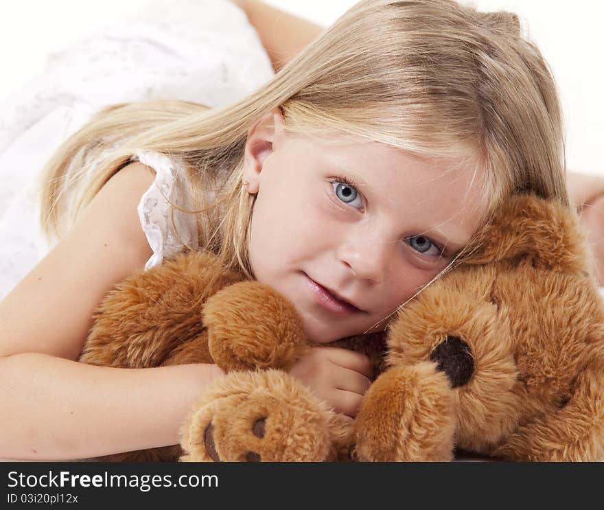 Angelic little girl with her teddy bear on white. Angelic little girl with her teddy bear on white.