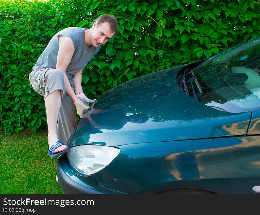 The man opens a car cowl