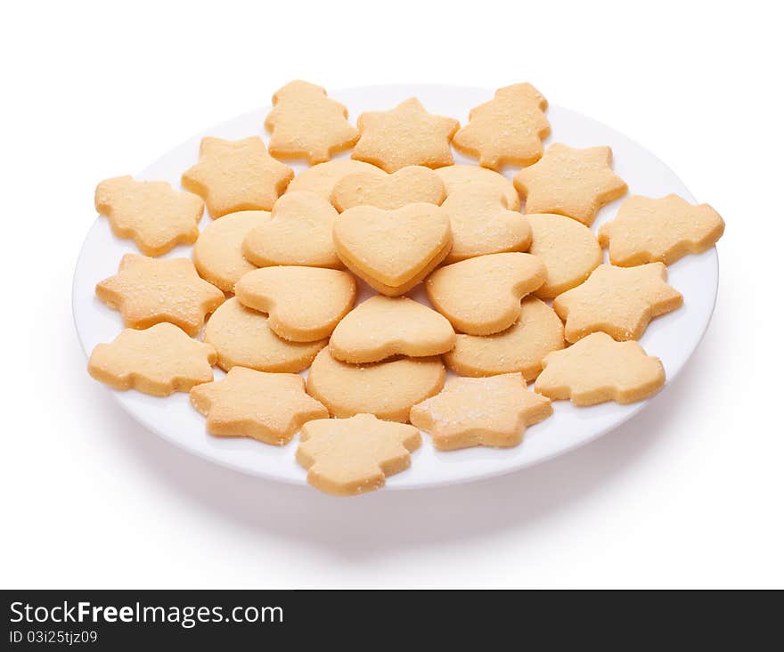 Cookies with different shapes on plate isolated on white background