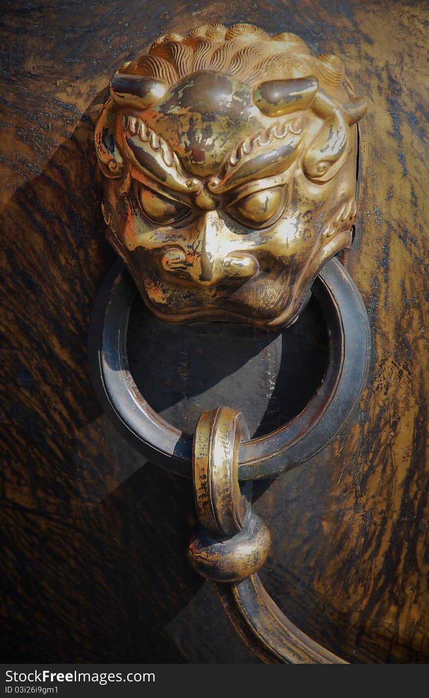 Bronze lion head on huge pot at Forbidden City, Beijing, China. Bronze lion head on huge pot at Forbidden City, Beijing, China