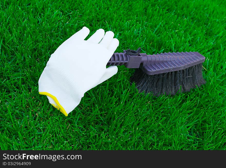 Brushes And A Glove On A Green Grass