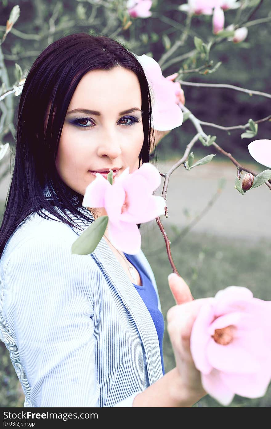 Beautiful Healthy Woman with magnolia flower