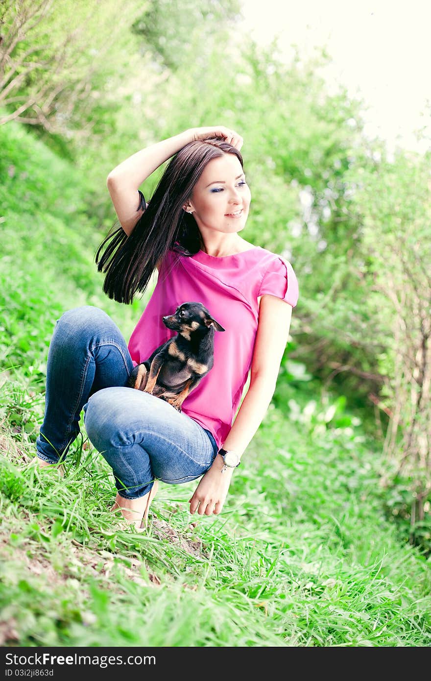 Beautiful Girl With A Puppy In The Garden