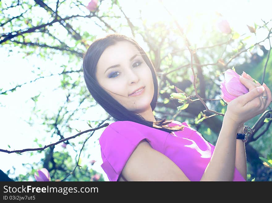 Beautiful healthy young Woman with spring flowers