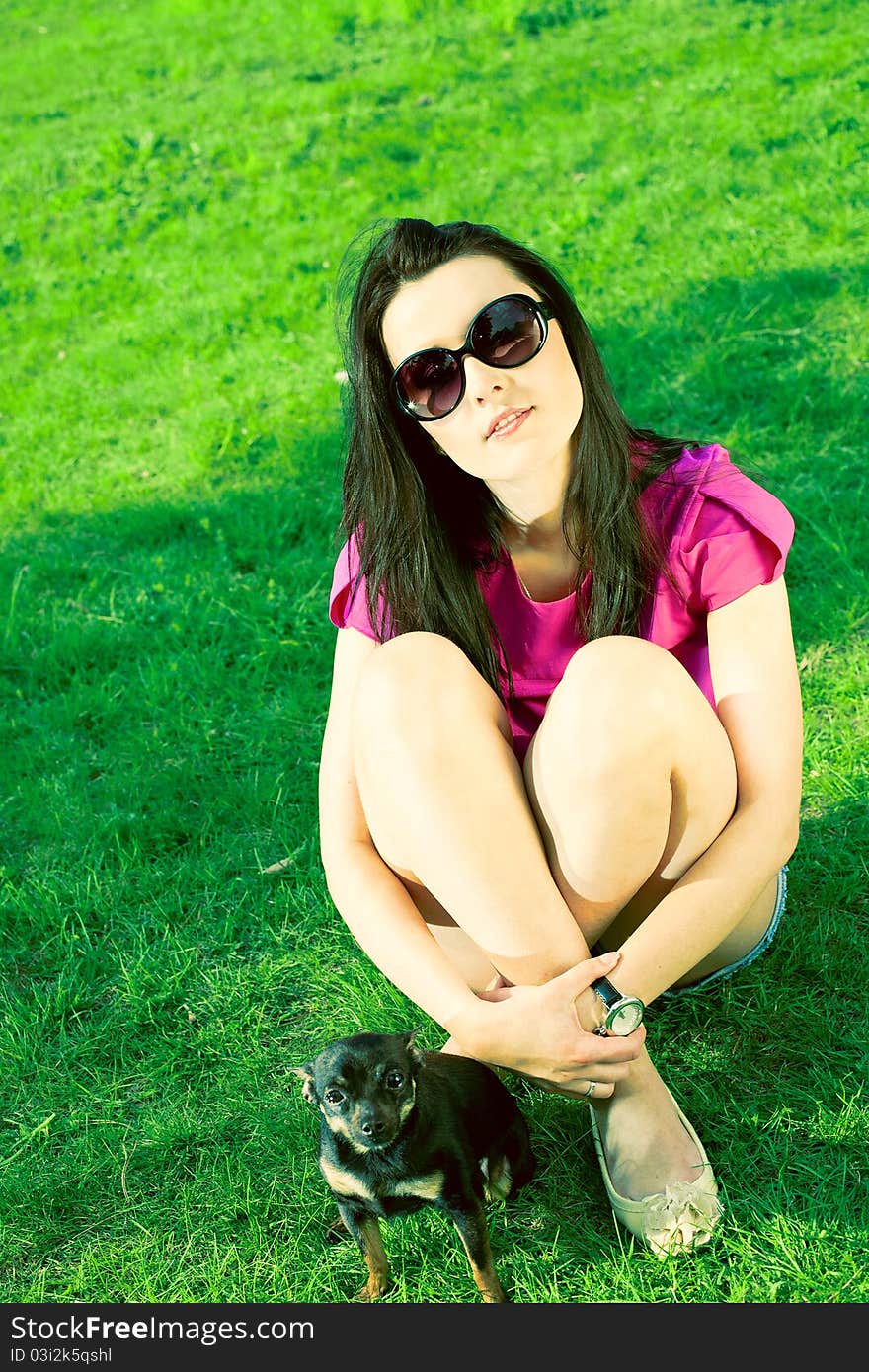 Girl With Glasses And A Puppy In The Garden