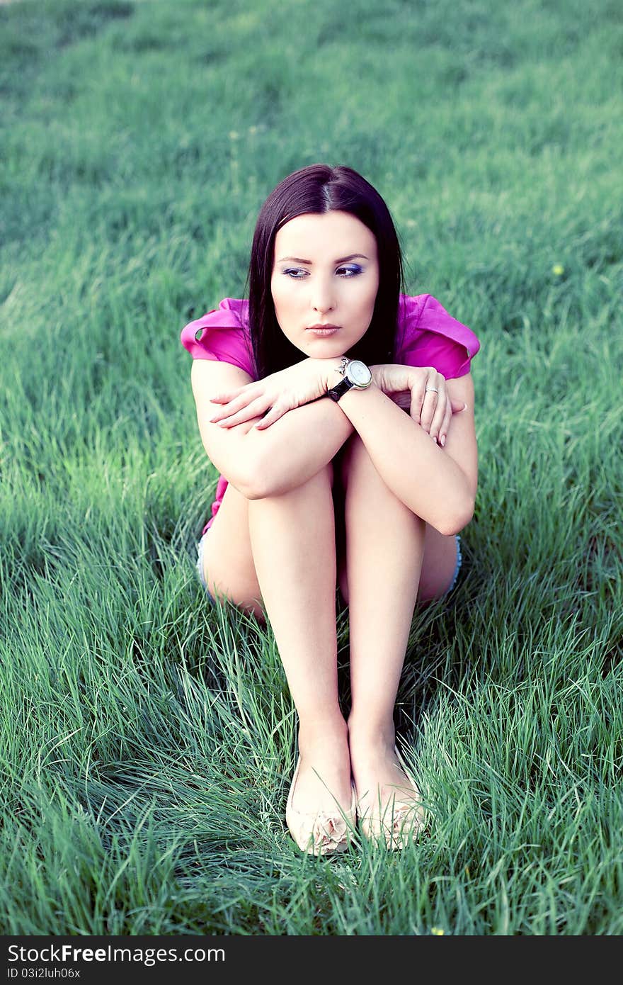 Pretty young woman outdoor in the grass