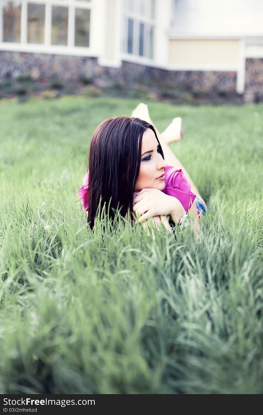 Woman laying on green grass. Woman laying on green grass