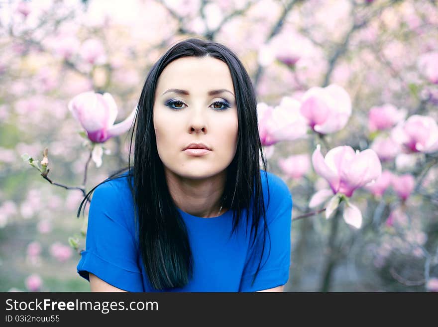 Girl and Magnolia flowers. Beauty