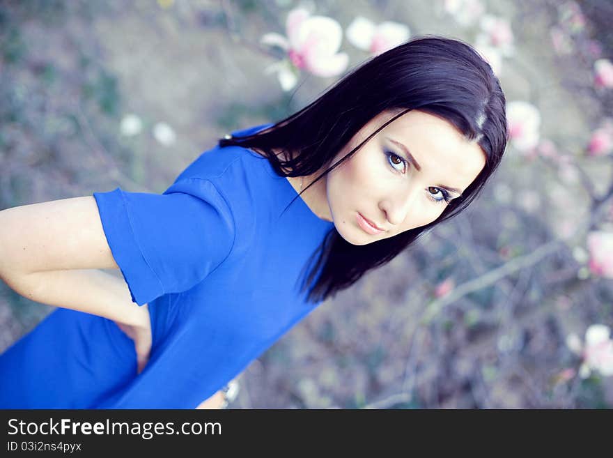 Attractive brunette in a blue dress