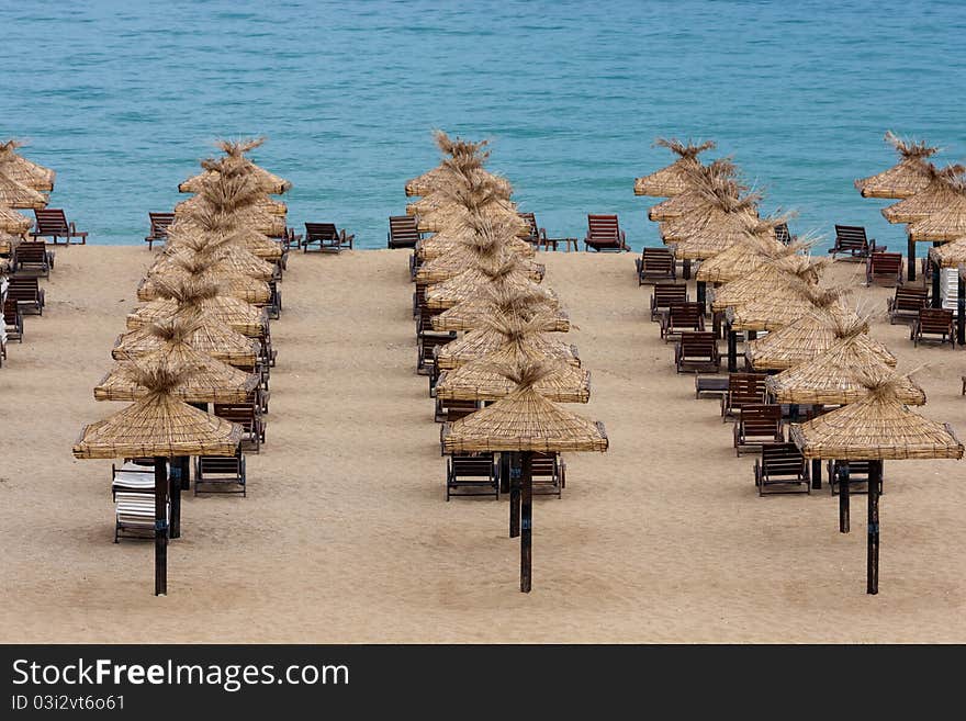 Empty beach with chairs and umbrellas in the morning