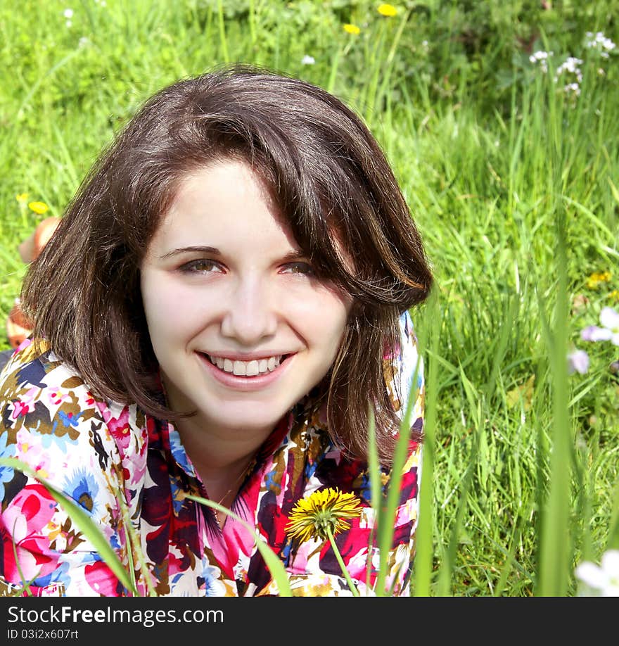 Smiling woman relaxes on the grass. Smiling woman relaxes on the grass