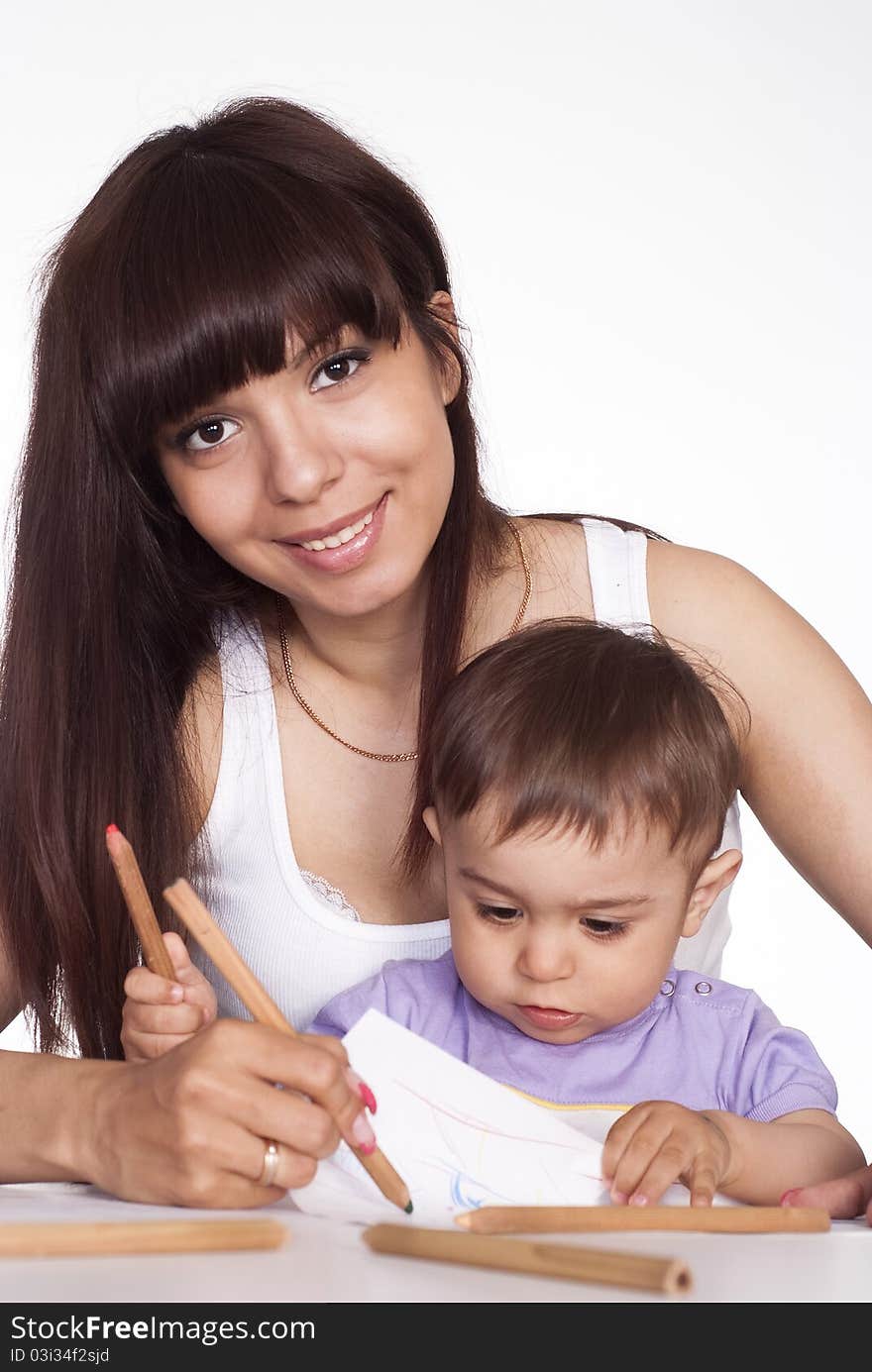 Cute mom with son drawing at table. Cute mom with son drawing at table