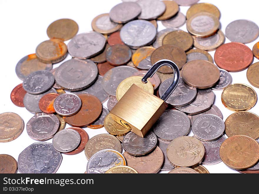 An open lock sitting on some scattered coins. An open lock sitting on some scattered coins