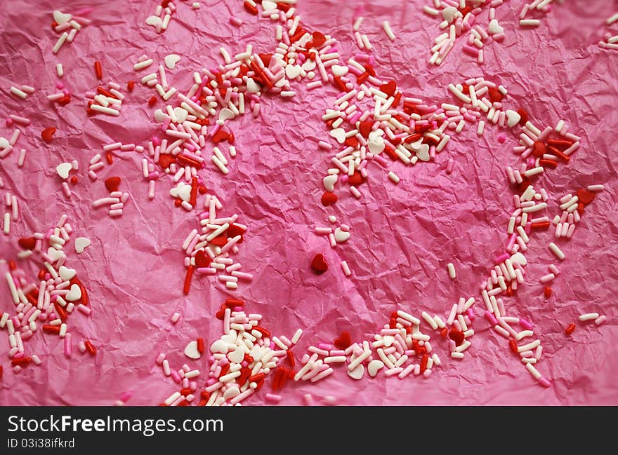 Pink tissue paper with red and white candy/hearst. Pink tissue paper with red and white candy/hearst