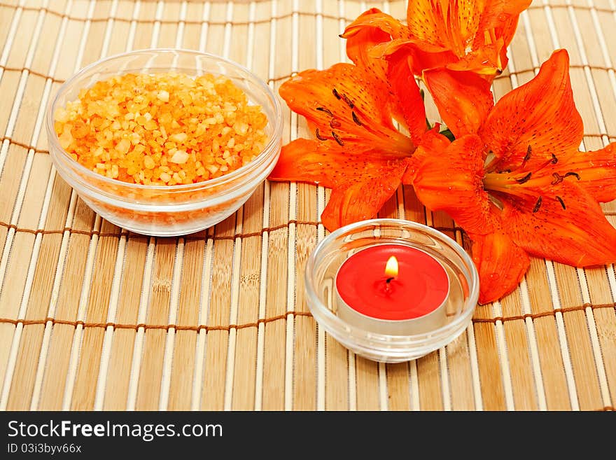 Lily flowers sea salt and essential oil with a candle. Lily flowers sea salt and essential oil with a candle