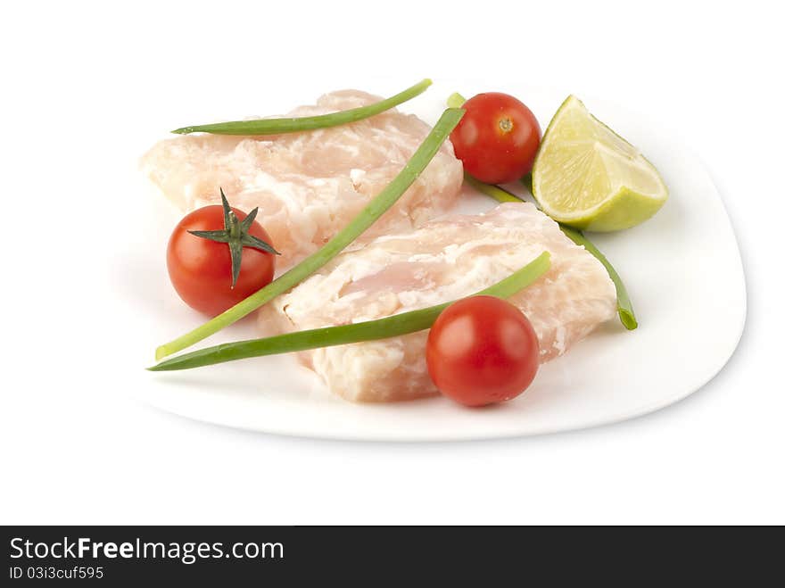 Pangasius fillet molded, decorated with cherry tomatoes and lime green onions