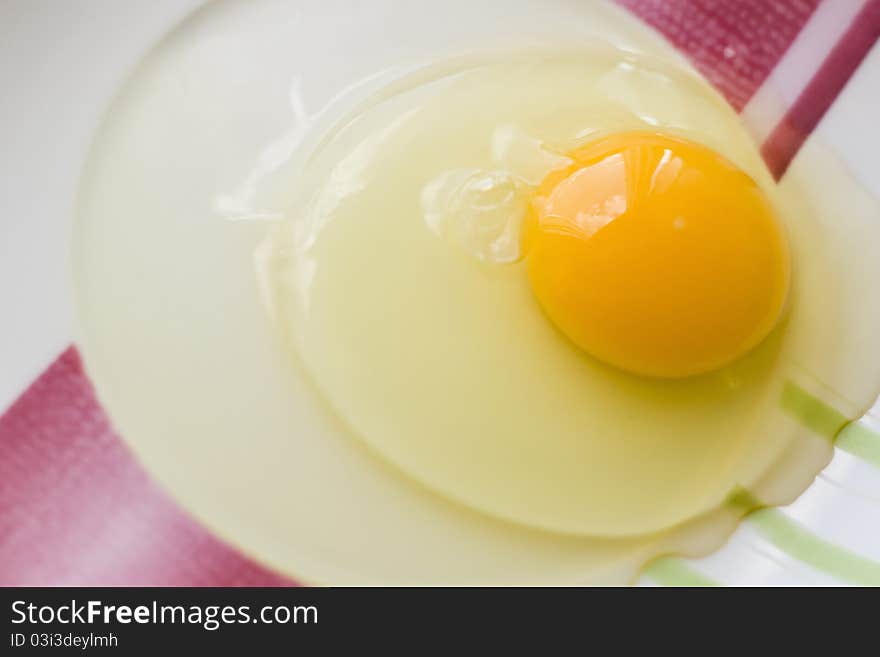 Raw egg in the dish, prepared for cooking