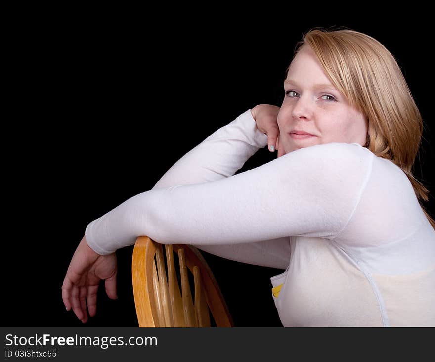 Pretty Girl in a White Shirt Sitting on a Chair