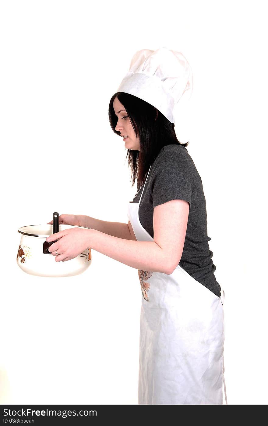 A pretty young woman, holding a cook pot, standing with an apron, black hair and a cook hat for white background. A pretty young woman, holding a cook pot, standing with an apron, black hair and a cook hat for white background.