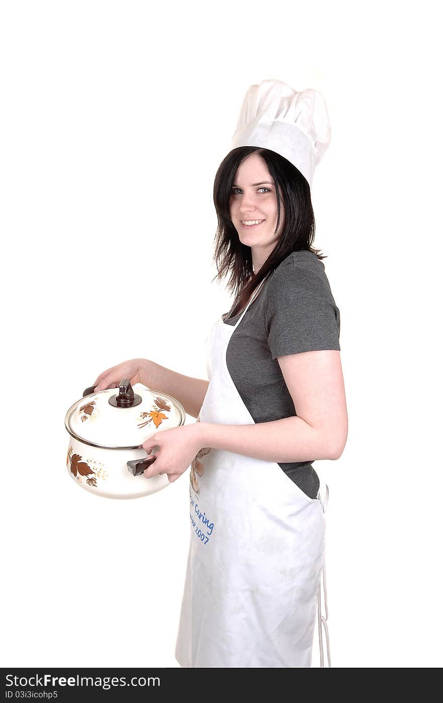 A pretty young woman, holding a cook pot, standing with an apron, black hair and a cook hat for white background. A pretty young woman, holding a cook pot, standing with an apron, black hair and a cook hat for white background.