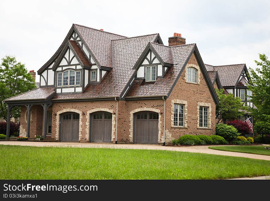 Image of a single family home with many windows and beautiful landscaping. Image of a single family home with many windows and beautiful landscaping.