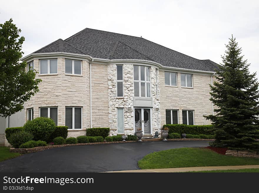 Image of a single family home with many windows and beautiful landscaping. Image of a single family home with many windows and beautiful landscaping.