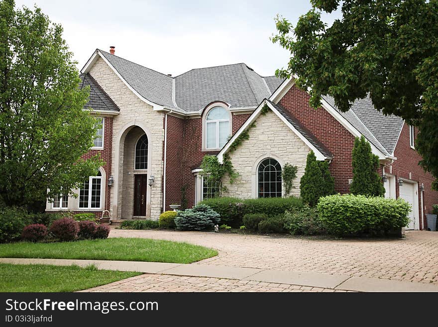 Image of a single family home with many windows and beautiful landscaping. Image of a single family home with many windows and beautiful landscaping.