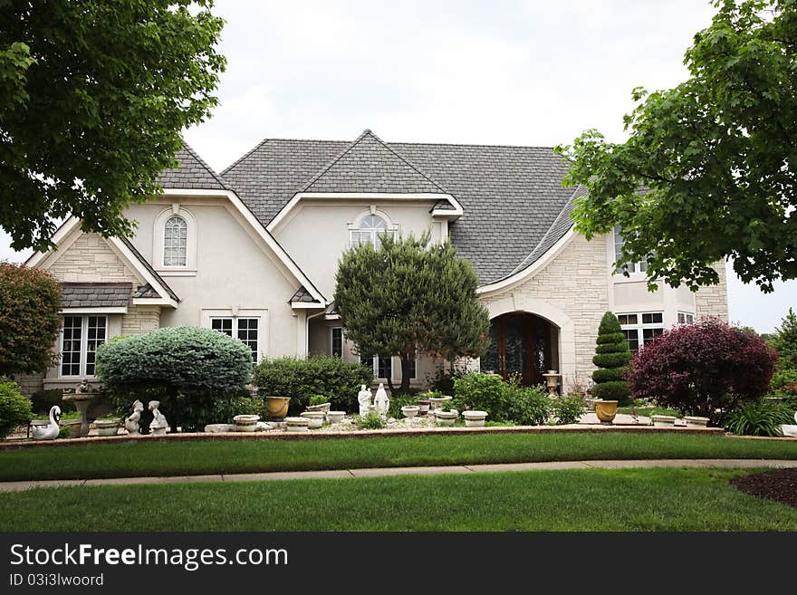 Image of a single family home with many windows and beautiful landscaping. Image of a single family home with many windows and beautiful landscaping.