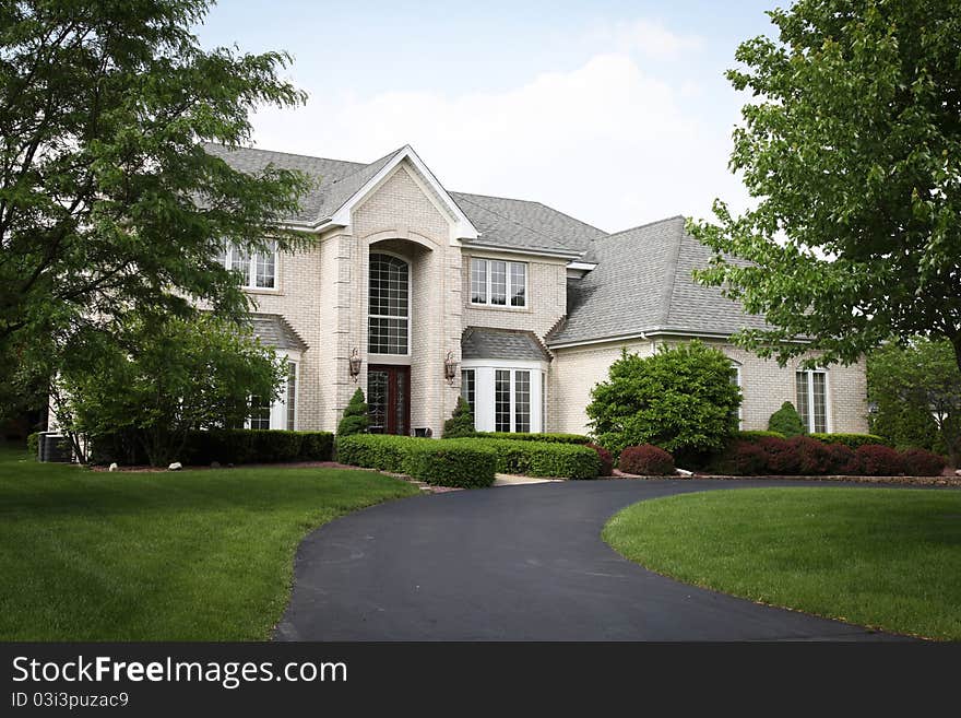 Image of a single family home with many windows and beautiful landscaping. Image of a single family home with many windows and beautiful landscaping.