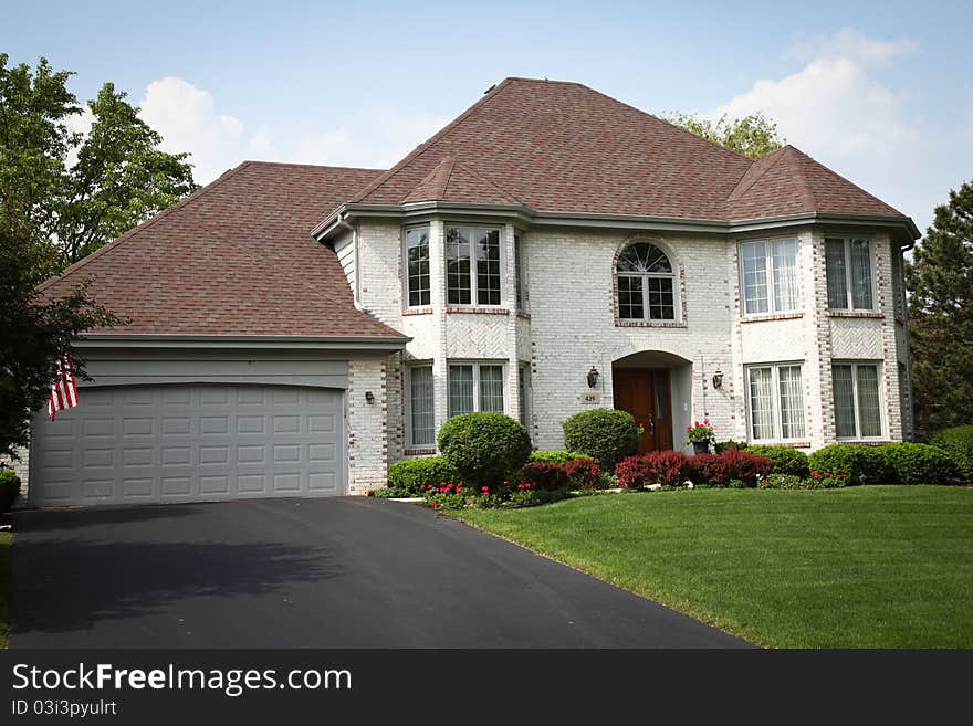 Image of a single family home with many windows and beautiful landscaping. Image of a single family home with many windows and beautiful landscaping.