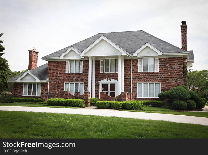 Image of a single family home with many windows and beautiful landscaping. Image of a single family home with many windows and beautiful landscaping.