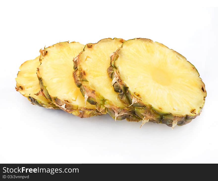 Ripe half pineapple with lush green leaves