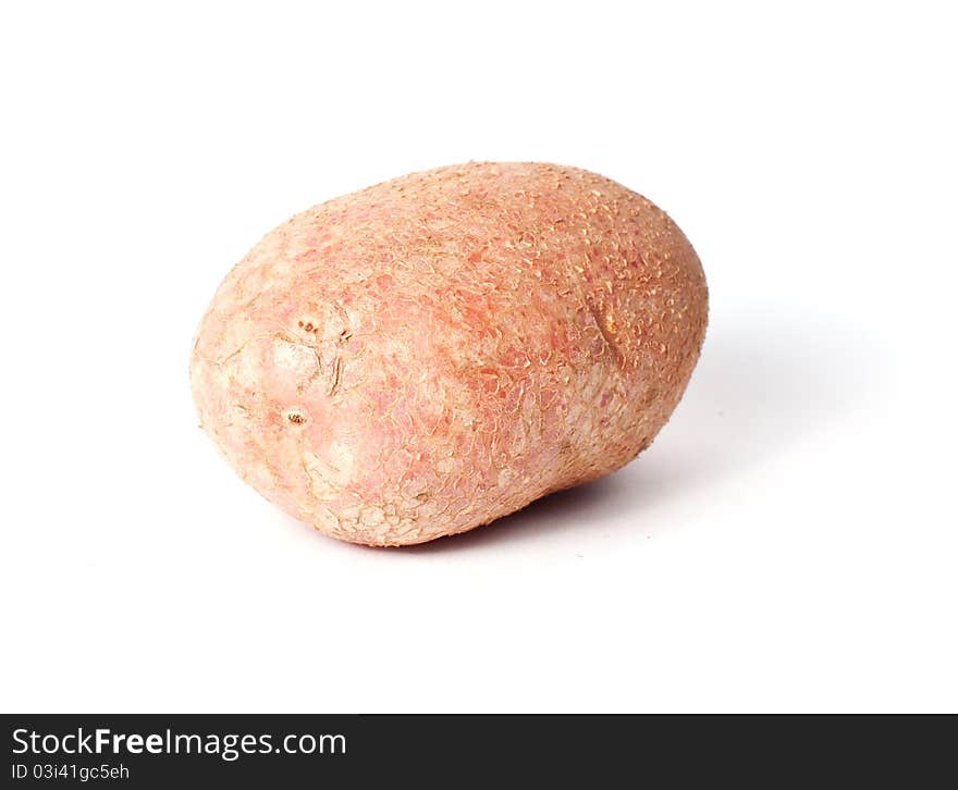 Single red potato closeup isolated on white background