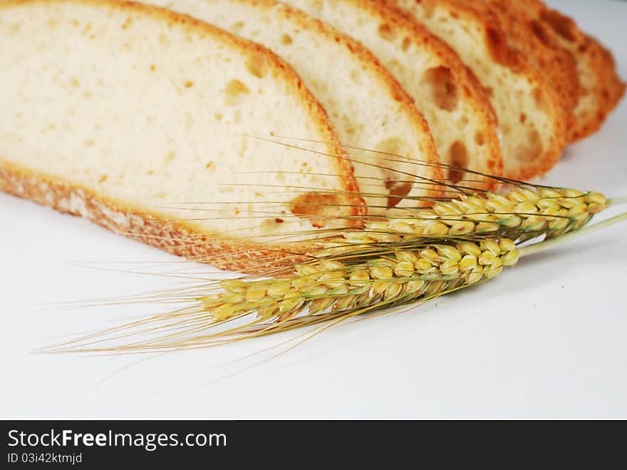 Slices of bread and ears on white background