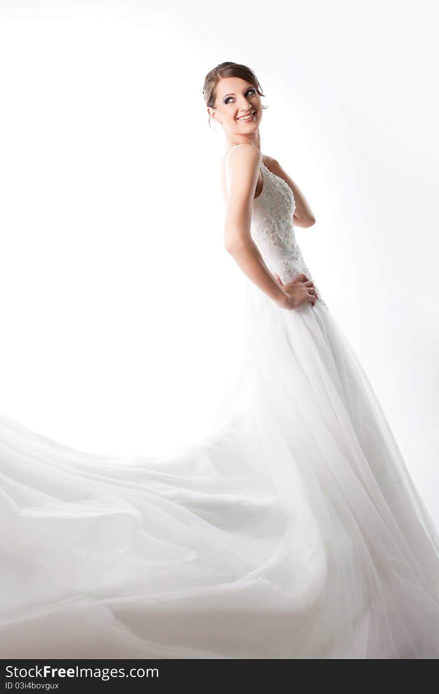 The beautiful high bride in a luxurious wedding dress, on a white background. The beautiful high bride in a luxurious wedding dress, on a white background