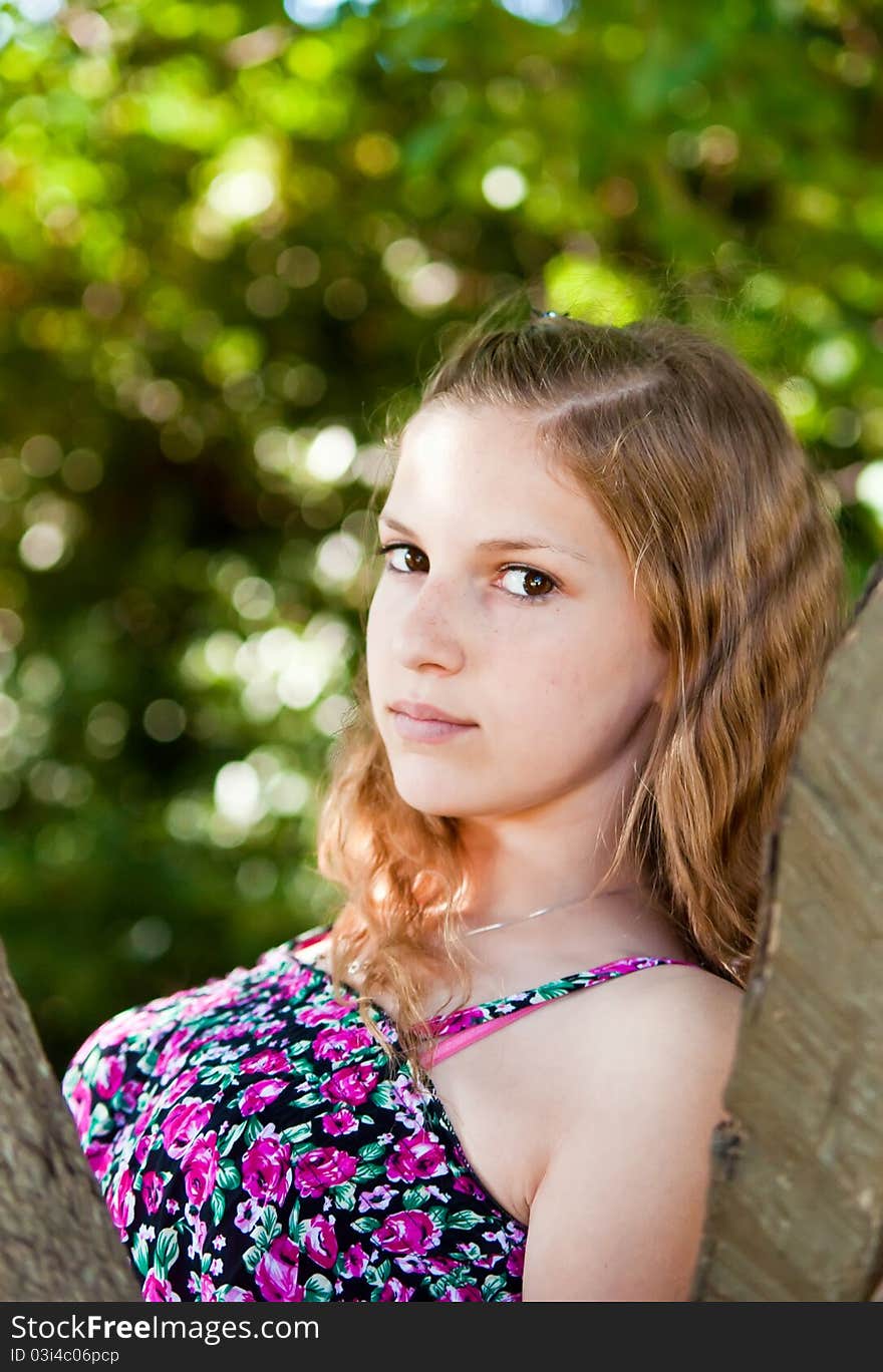 Portrait of a teen girl near the tree. Portrait of a teen girl near the tree.