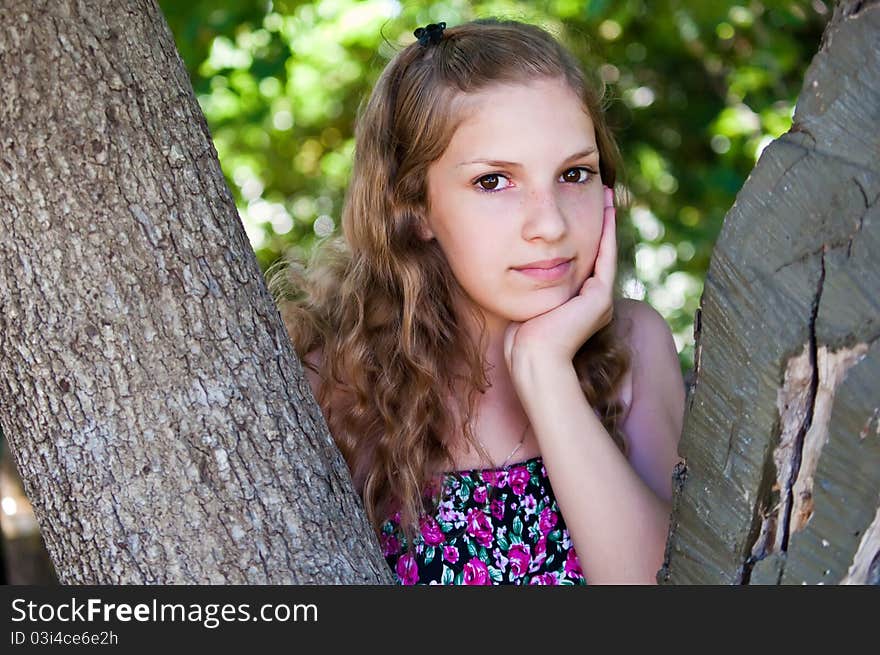 Portrait of a teen girl near the tree. Portrait of a teen girl near the tree.