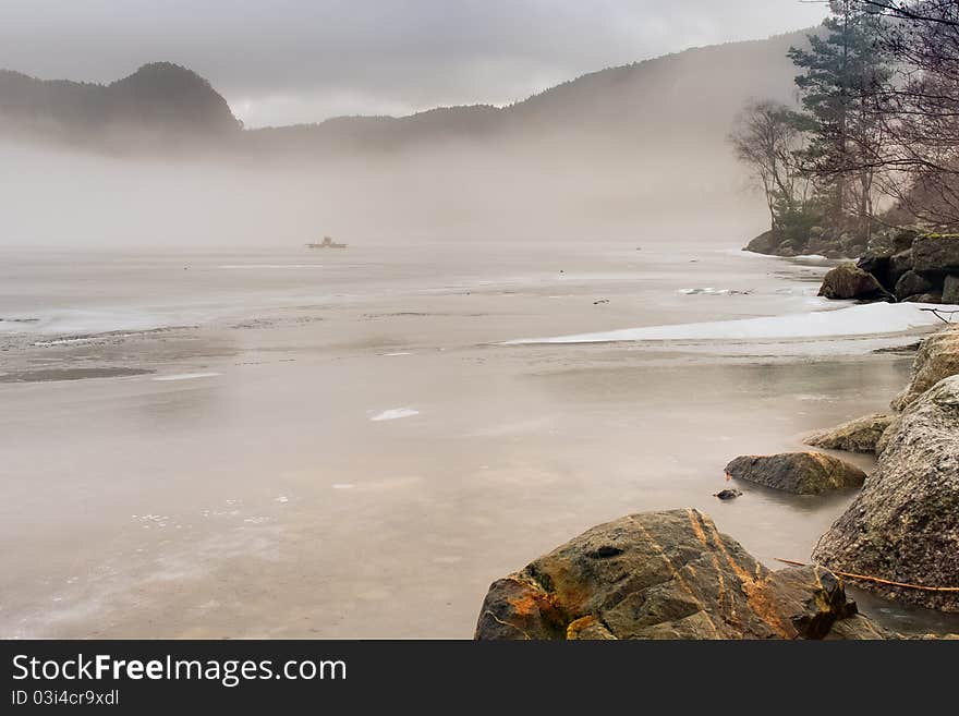 Foggy icy lake