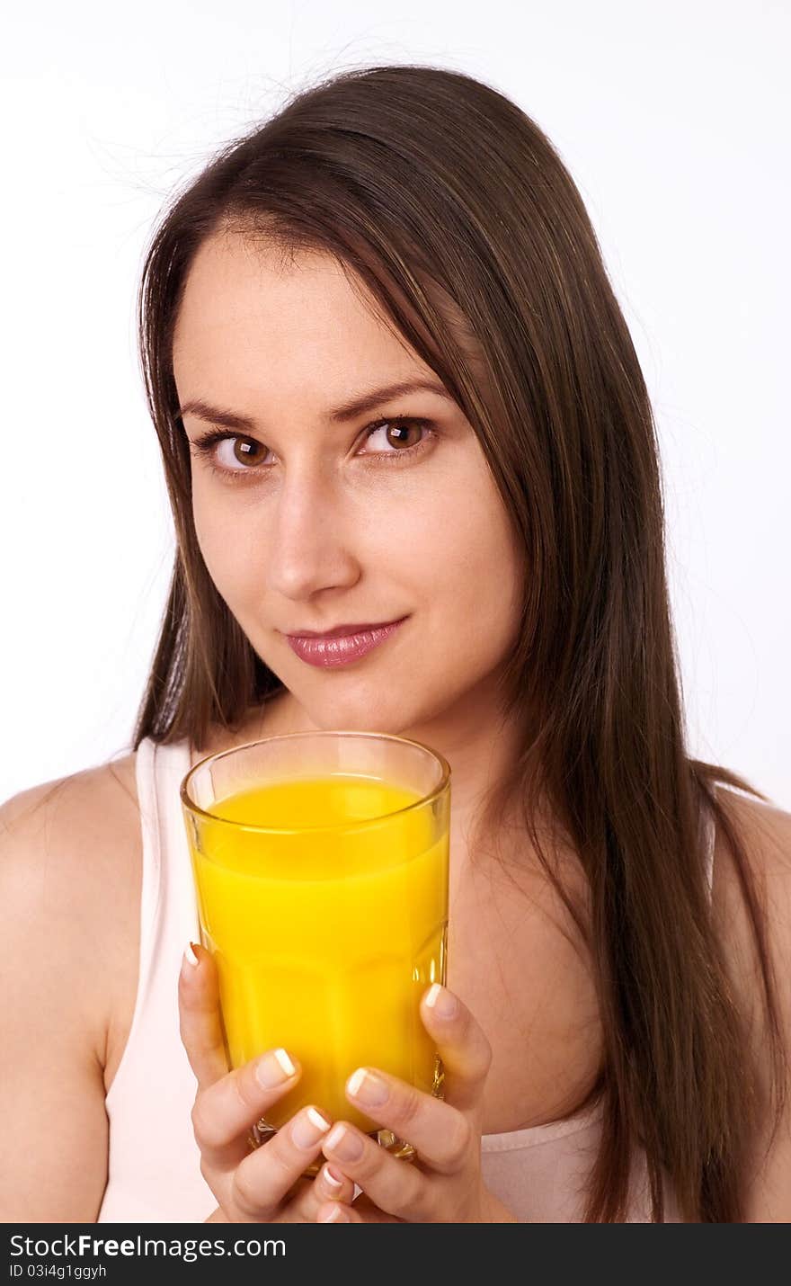 Attractive young woman holding a glass of orange juice. Attractive young woman holding a glass of orange juice