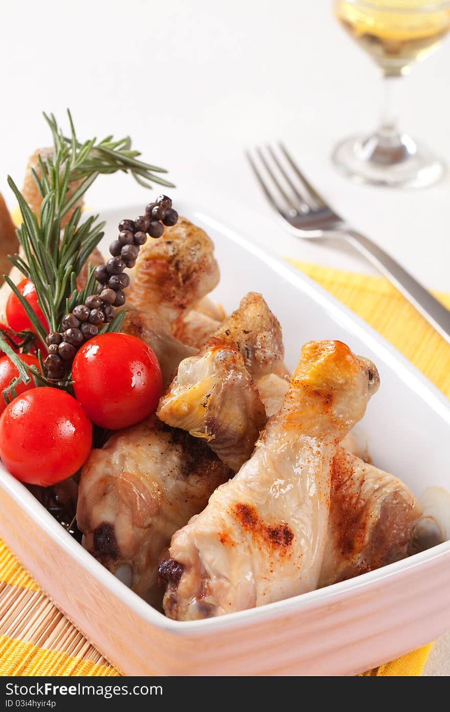 Roasted chicken drumsticks in a casserole dish