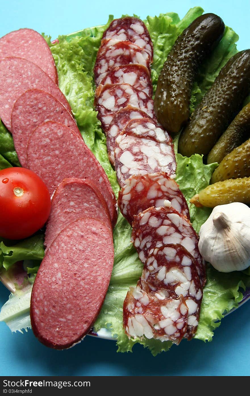 Plate with vegetables and sausage cutting. Plate with vegetables and sausage cutting