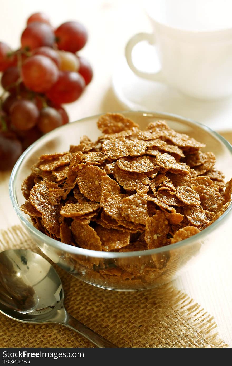 Chocolate muesli in bowl and grapes