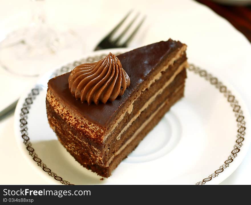 Chocolate cake with creme on plate