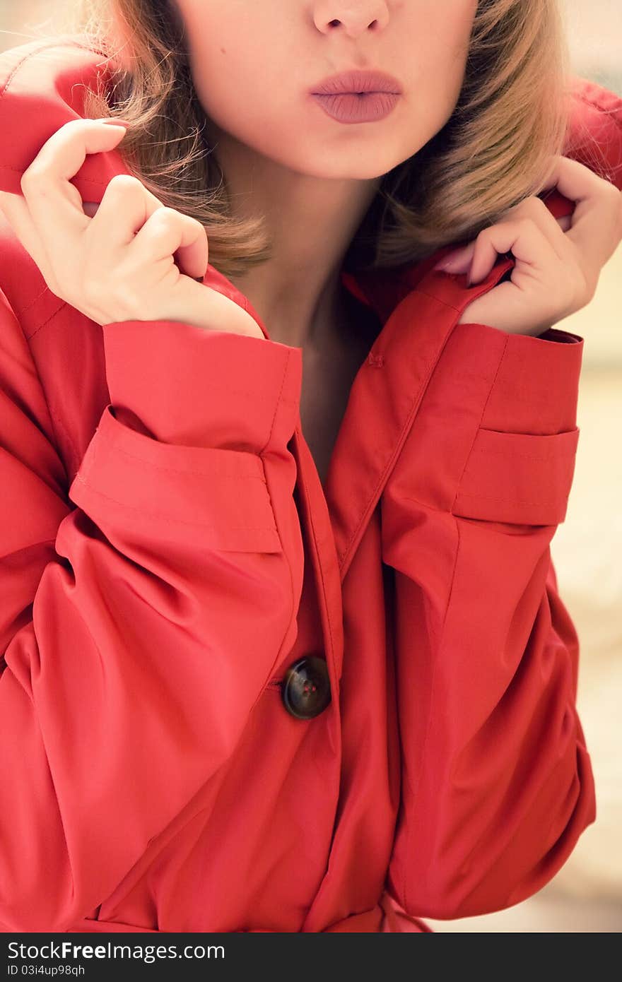 Young girl in a raincoat closeup (selective focus)