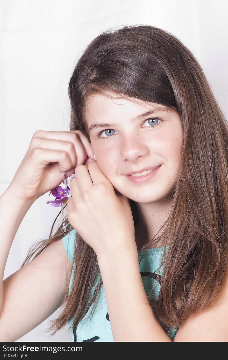 Young girl with trendy fashionable orchid earring. Young girl with trendy fashionable orchid earring