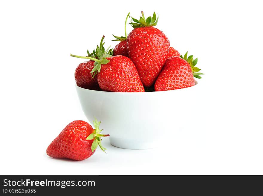 An image of bright red strawberries in a white cup. An image of bright red strawberries in a white cup