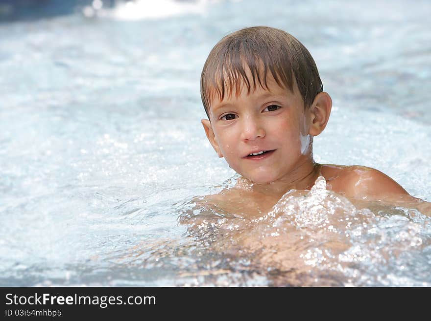 Young boy swimming in pool