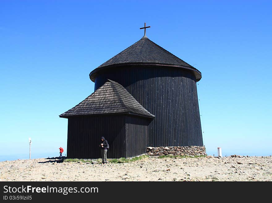 Old wooden church in the blue sky background.