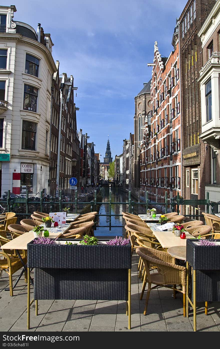 Outdoor terrace restaurant on the canal in Amsterdam. Urban scene